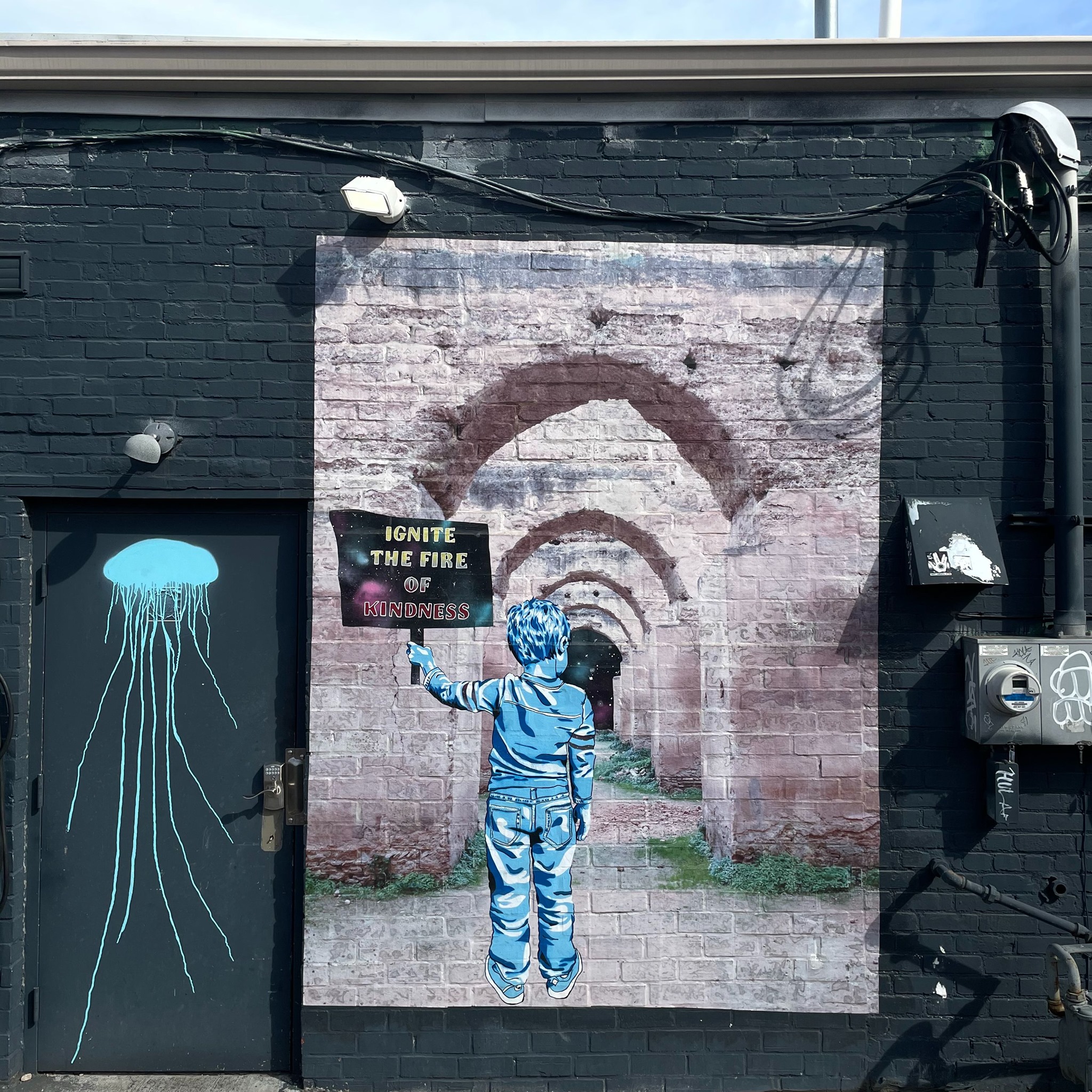Stephanie Rond’s murals and street art are infused with messages of compassion and community. Pictured here is the mural titled “Echoes of Kindness,” and it can be seen on the corner of Hudson & Summit in Columbus, Ohio.  